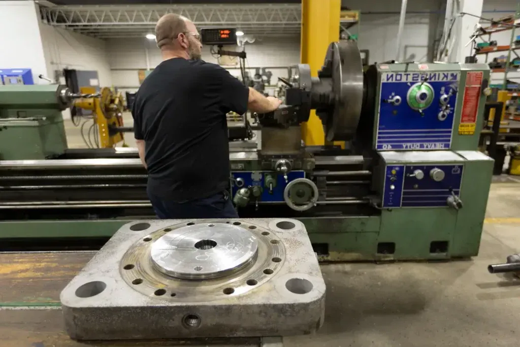 Man repairing cylinder with a machine